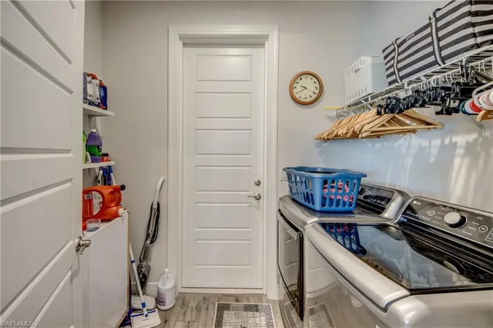 Laundry area featuring separate washer and dryer and light wood finished floors