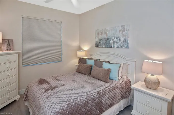 Bedroom with wood finished floors and baseboards