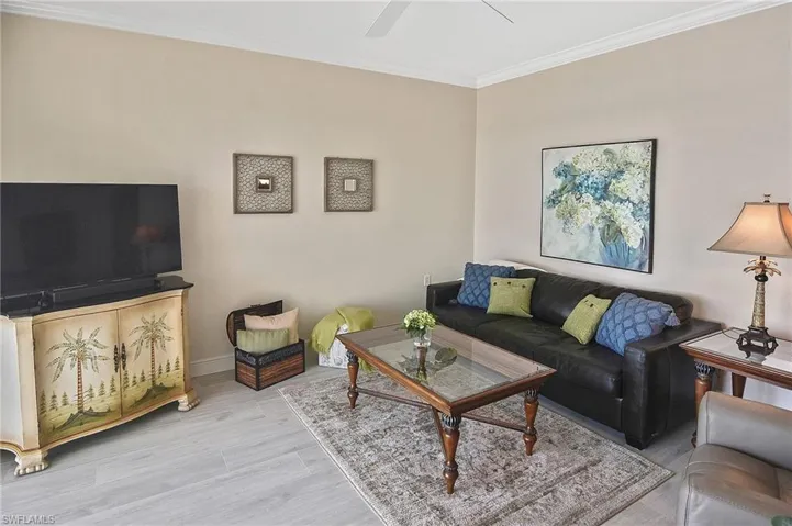 Living room featuring crown molding and wood finished floors