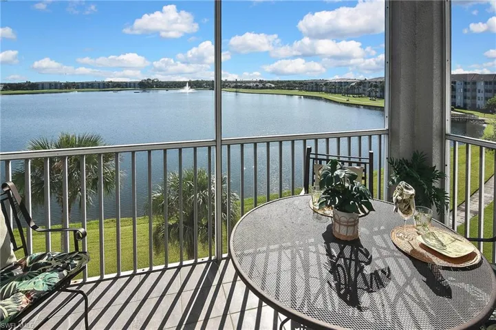 Balcony featuring a sunroom and a water view