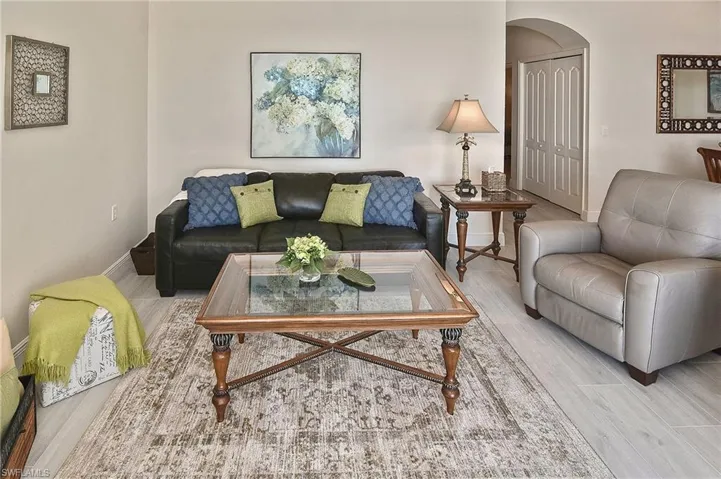 Living room featuring arched walkways and wood finished floors