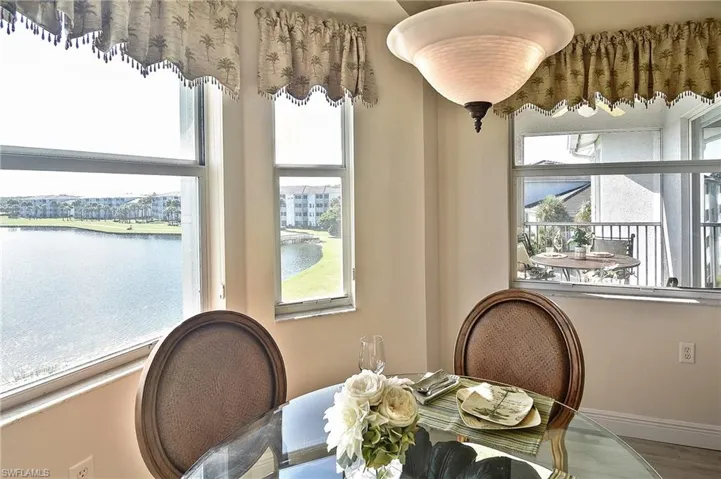 Dining space featuring a water view and baseboards