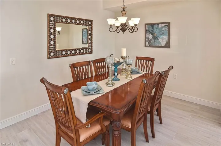 Dining area featuring light wood-style floors and a chandelier