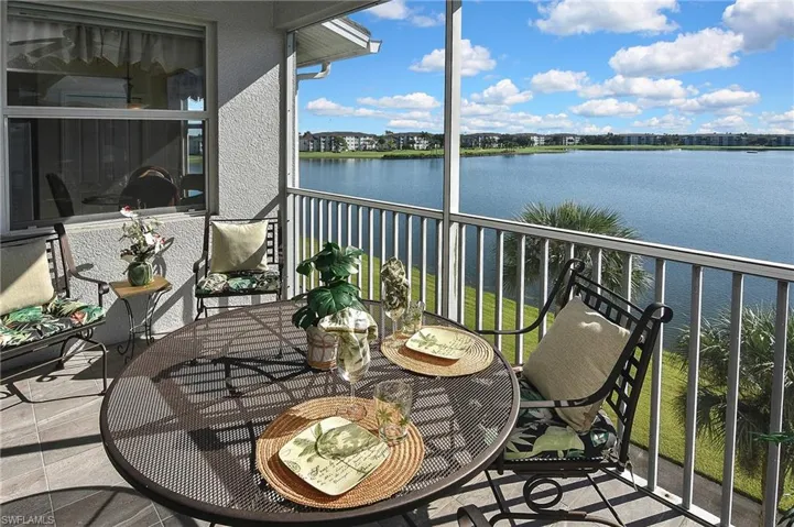 Balcony featuring a water view and a sunroom