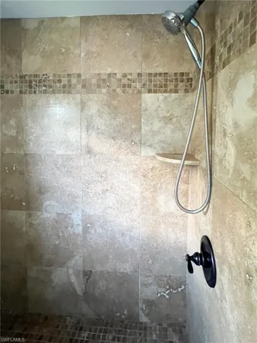 Room details featuring tiled shower