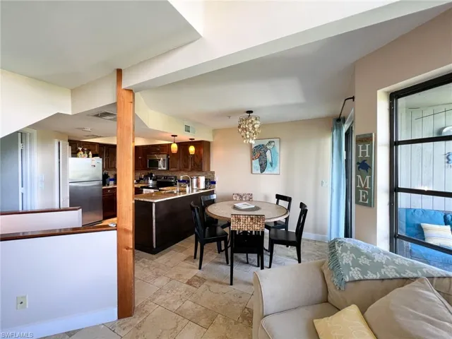 Tiled dining area featuring an inviting chandelier