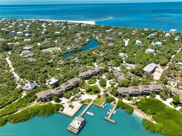 Birds eye view of property with a water view