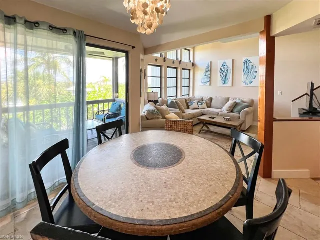 Tiled dining space featuring a chandelier