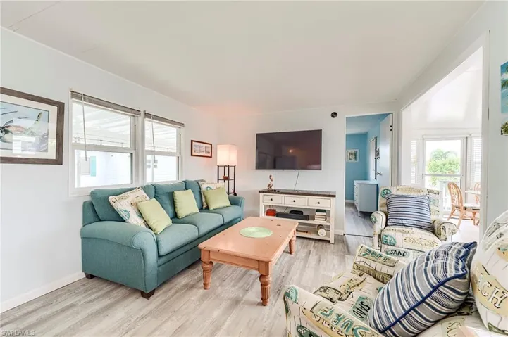 Living room featuring light wood-style floors and baseboards