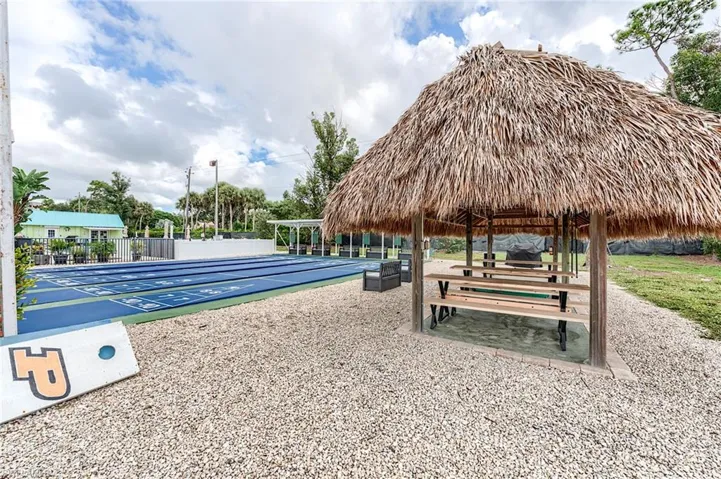View of community featuring shuffleboard and a patio