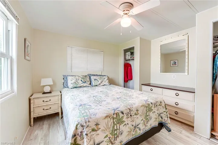 Bedroom featuring light wood finished floors, a ceiling fan, and a closet
