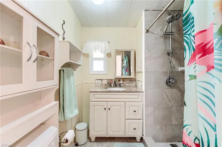Bathroom with a stall shower and vanity