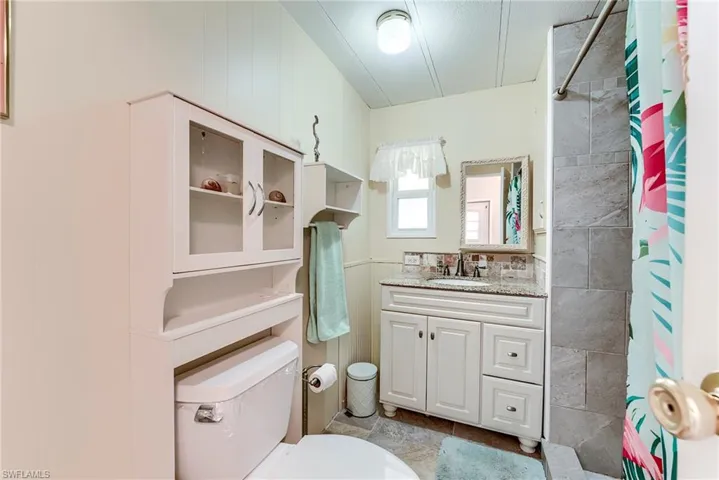 Full bathroom with vanity and a shower with curtain