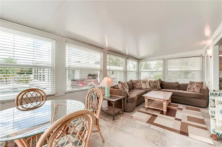 Sunroom / solarium featuring vaulted ceiling and tile patterned flooring