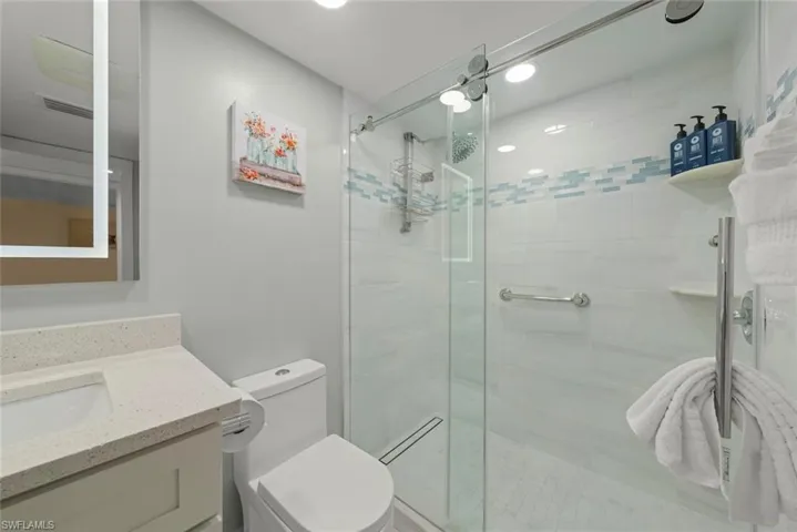 Full bath with vanity and a stall shower