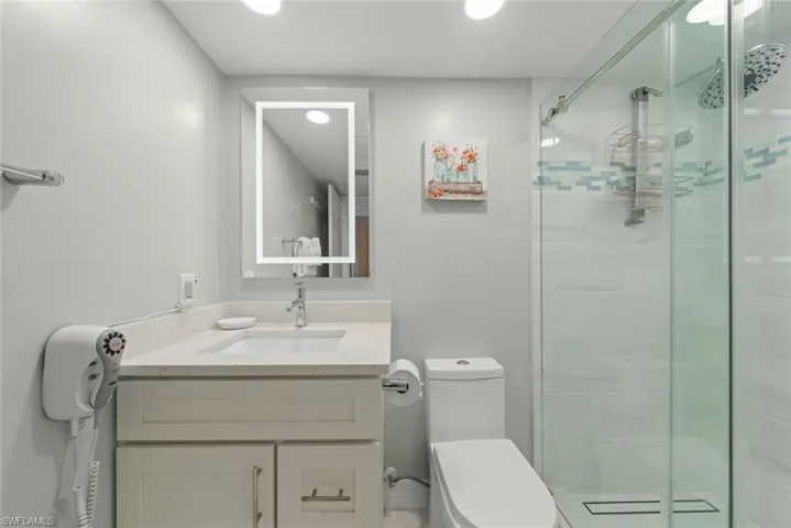 Bathroom with vanity and a stall shower