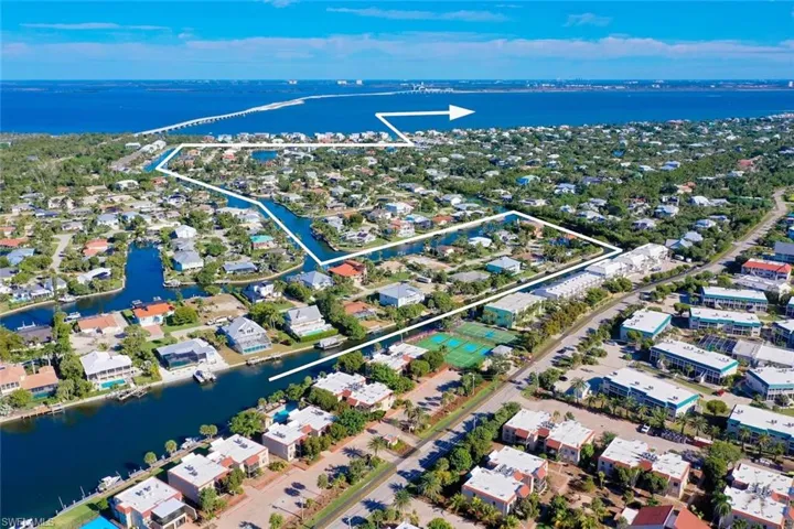 Aerial overview of property's location featuring nearby suburban area and property parcel outlined