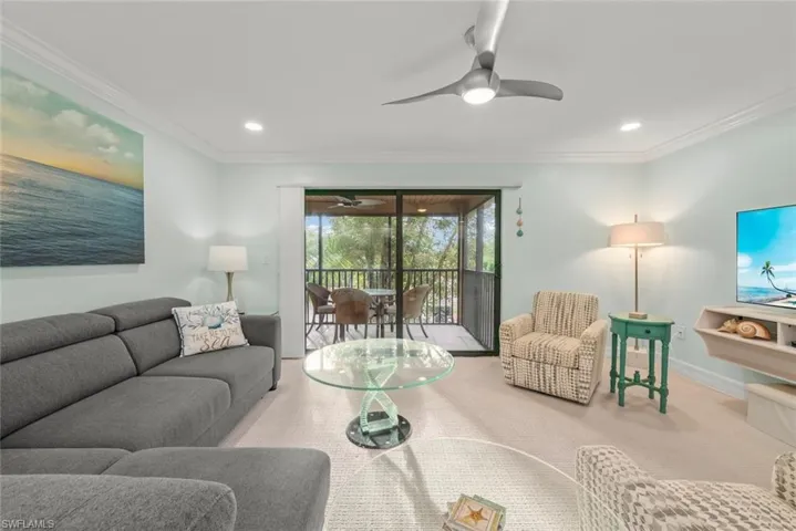 Living area with crown molding, carpet, recessed lighting, a sunroom, and a ceiling fan