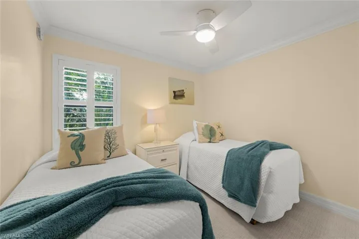 Bedroom featuring ornamental molding and ceiling fan