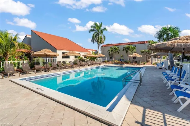 Community pool with a patio area and a gazebo