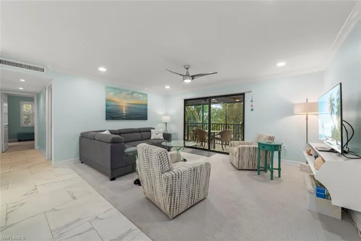 Living area featuring crown molding, ceiling fan, light marble finish floors, and recessed lighting