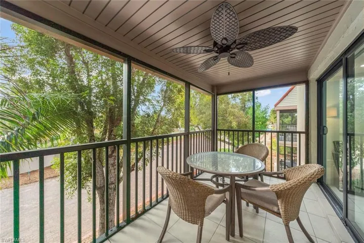 Sunroom / solarium featuring a ceiling fan and a balcony