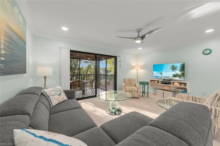 Living area featuring ceiling fan, crown molding, carpet flooring, and recessed lighting