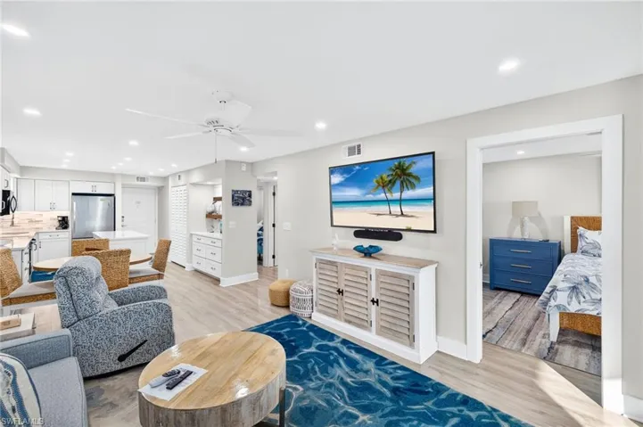 Living room with light wood-style floors, recessed lighting, and a ceiling fan