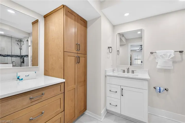 Full bathroom with vanity, a stall shower, and recessed lighting