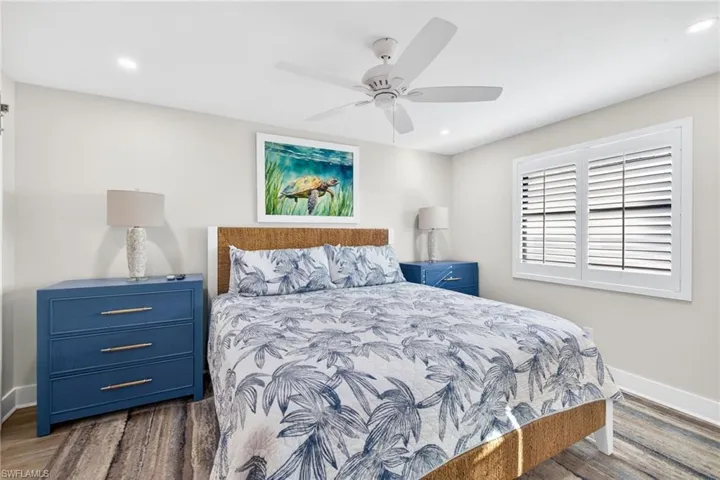 Bedroom featuring ceiling fan, dark wood finished floors, and recessed lighting