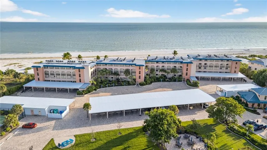 Aerial view of expansive coastline and apartment complex / building