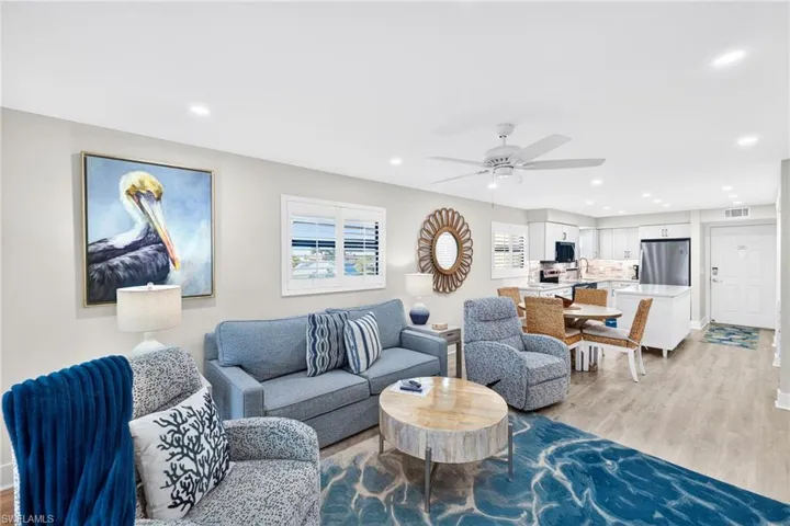 Living area with light wood-style flooring, recessed lighting, and a ceiling fan