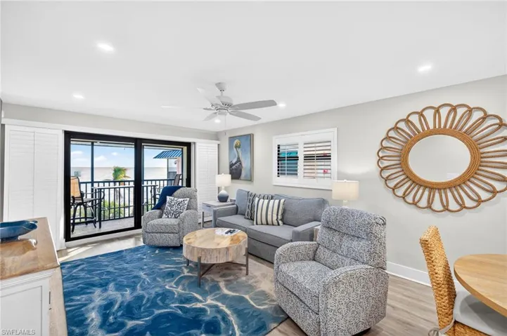 Living room featuring wood finished floors, a ceiling fan, and recessed lighting