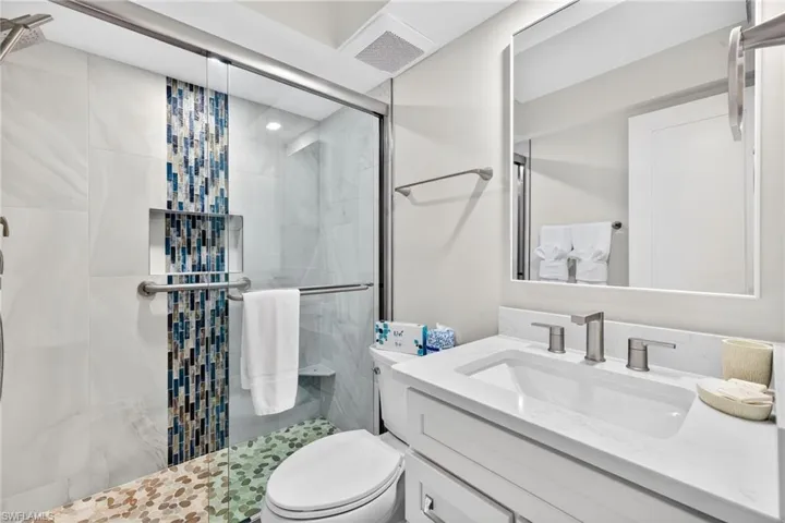 Full bathroom with a stall shower and vanity
