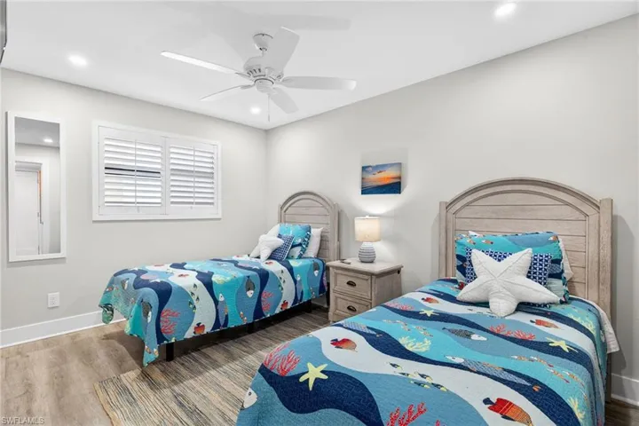 Bedroom featuring wood finished floors, ceiling fan, and recessed lighting