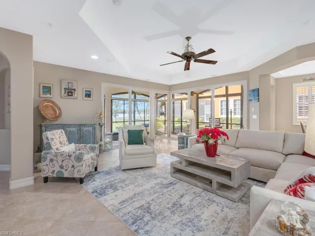 Living room featuring a wealth of natural light, ceiling fan, and light tile patterned floors