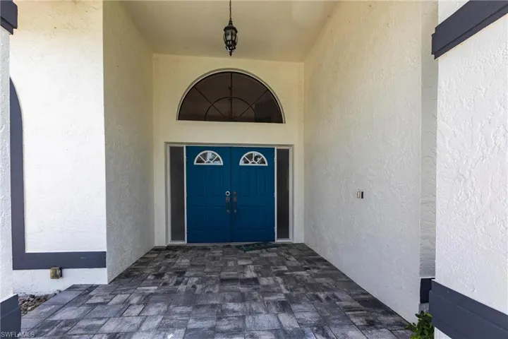 View of exterior entry featuring stucco siding
