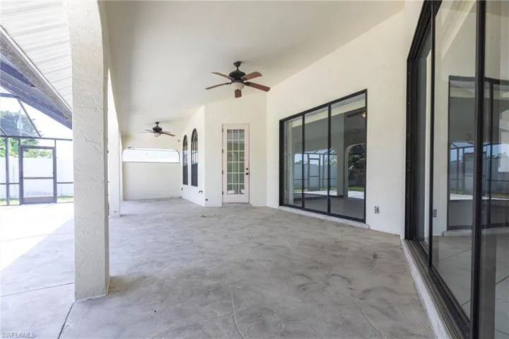 View of patio / terrace featuring ceiling fan and a lanai