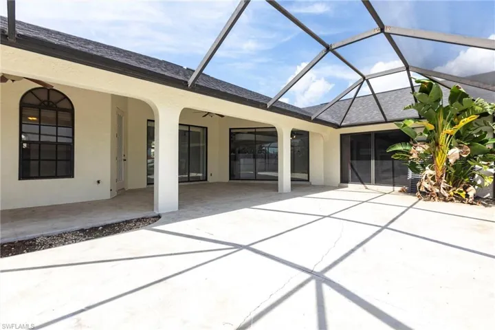 View of patio / terrace featuring ceiling fan and a lanai