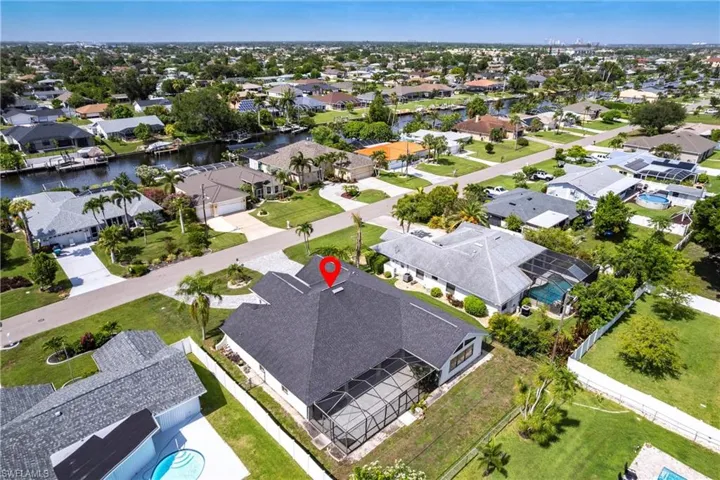 Aerial perspective of suburban area featuring a nearby body of water