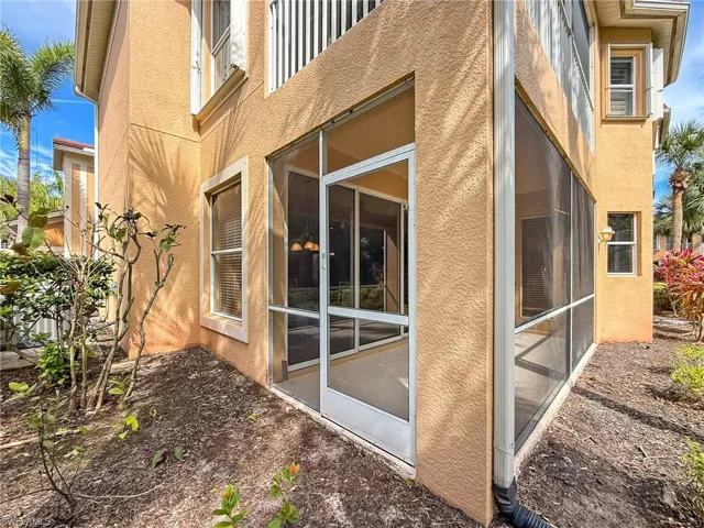 View of home's exterior featuring a sunroom and stucco siding