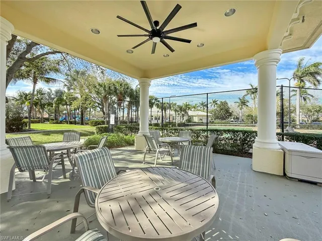 View of patio / terrace with outdoor dining space, fence, and a ceiling fan