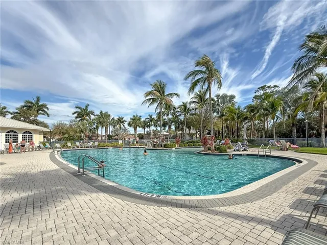 Pool with a patio area and fence