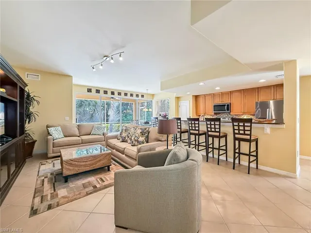 Living area featuring light tile patterned floors, baseboards, visible vents, and recessed lighting