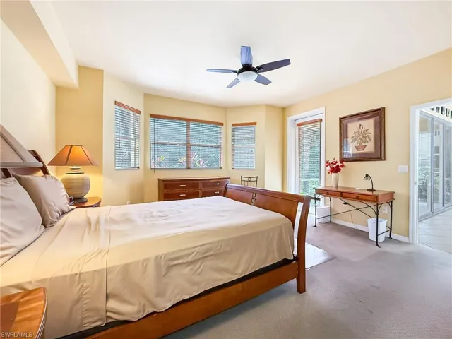 Bedroom with carpet floors, baseboards, and a ceiling fan