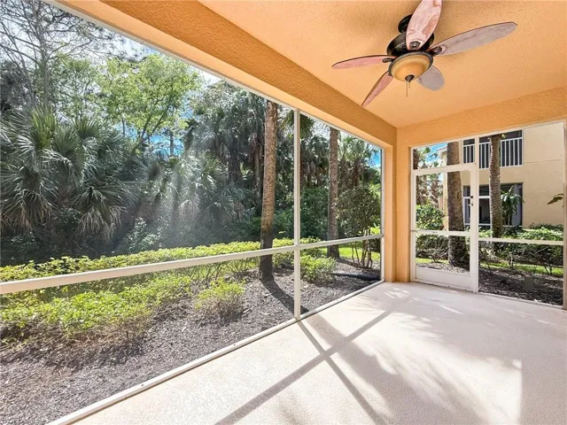 Unfurnished sunroom with ceiling fan