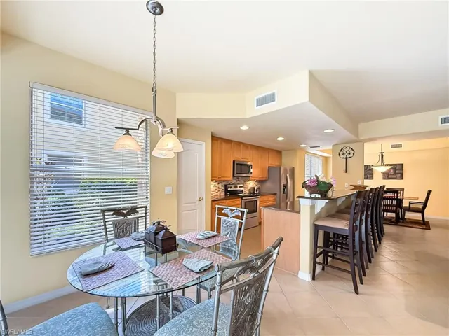 Dining area featuring recessed lighting, visible vents, baseboards, and light tile patterned floors