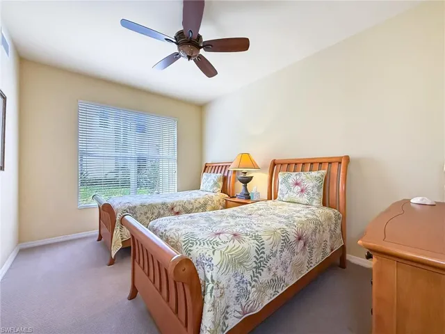 Bedroom featuring carpet floors, a ceiling fan, and baseboards