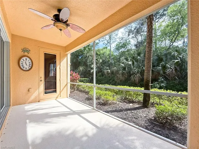 Unfurnished sunroom with ceiling fan