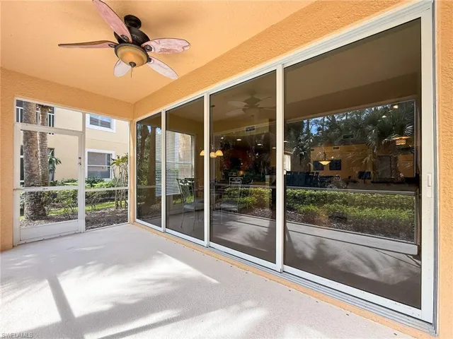 Unfurnished sunroom featuring ceiling fan